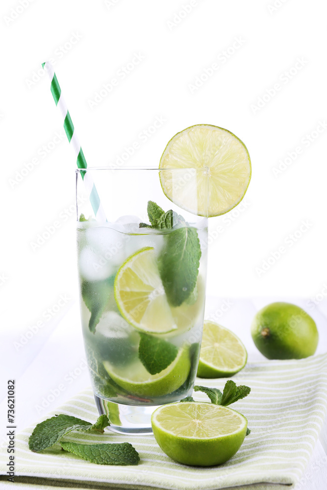 Fototapeta premium Lemonade in glass on napkin on bright background