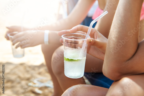 Group of people drinking cocktails on the beach