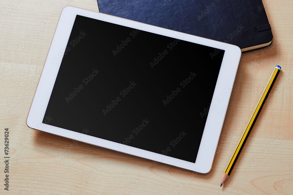 Tablet pc with a blank screen on a wooden desk Tablet pc with a blank screen on a wooden desk