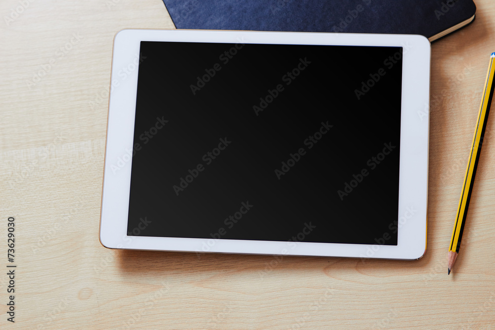 Blank screen on a white tablet pc with an organiser and a pencil Blank screen on a white tablet pc with an organiser and a pencil