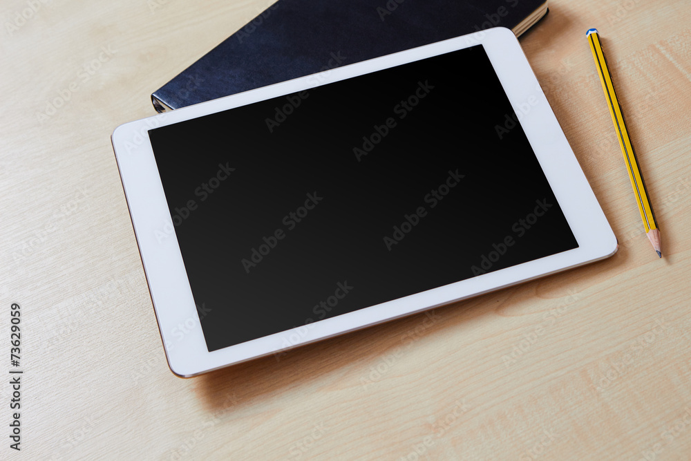 Blank screen on a white tablet pc with an organiser and a pencil Blank screen on a white tablet pc with an organiser and a pencil