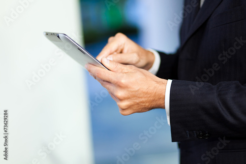 Businessman using his digital tablet © Minerva Studio