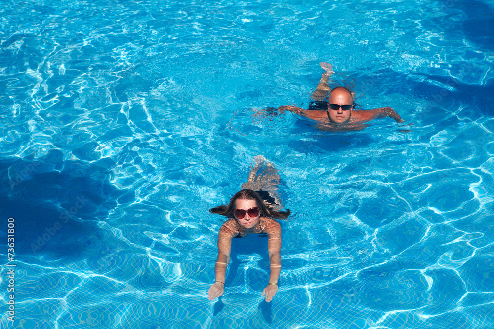 Couple swimming in pool