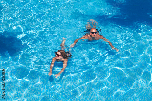 Couple swimming in pool