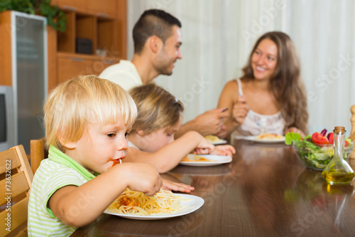 Family of four eating spaghetti