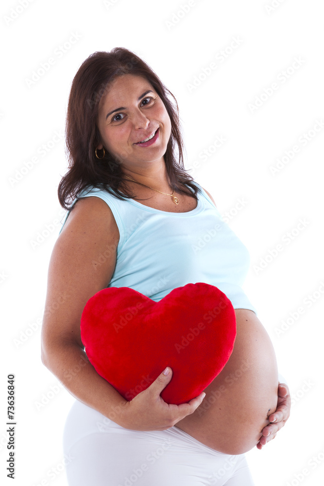 Happy pregnant woman holding a heart shape Happy pregnant woman holding a heart shape