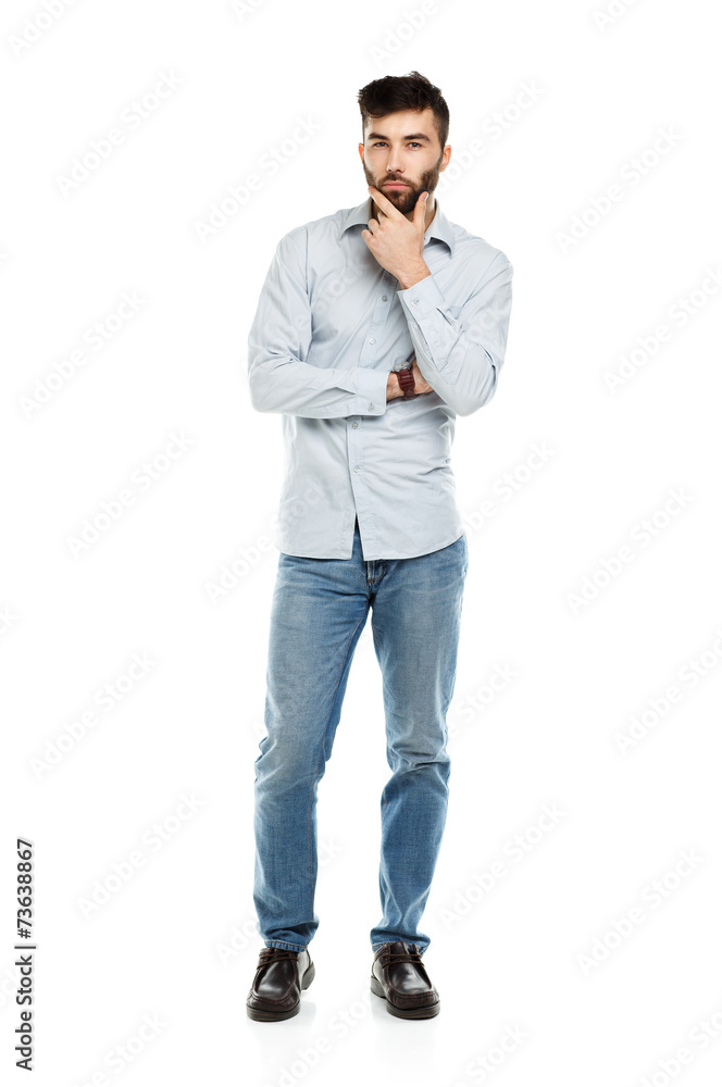 A young bearded man with a serious expression on his face isolat A young bearded man with a serious expression on his face isolat