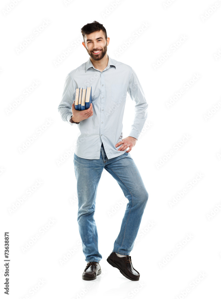Fototapeta premium Young bearded smiling man with books in hands on white