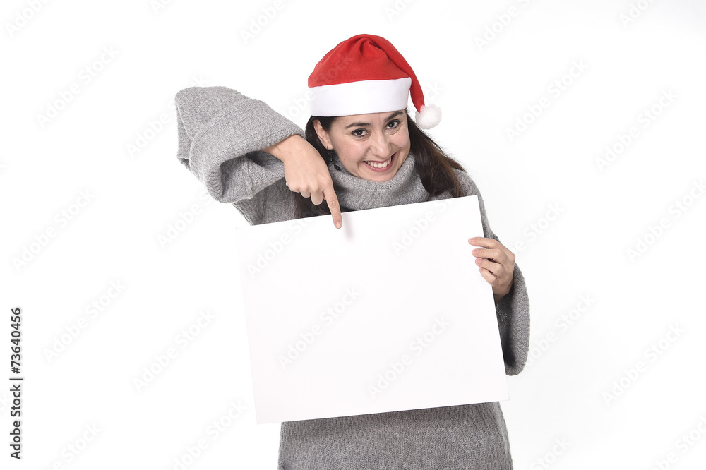 happy Latin woman Christmas Santa hat pointing blank billboard happy Latin woman Christmas Santa hat pointing blank billboard