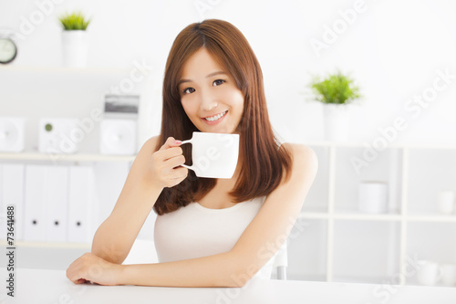 happy asian young drinking coffee