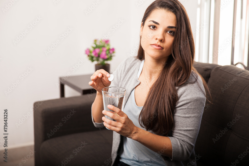 Hungover girl taking antacid Hungover girl taking antacid