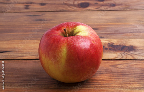 Red apple on rustic wooden background