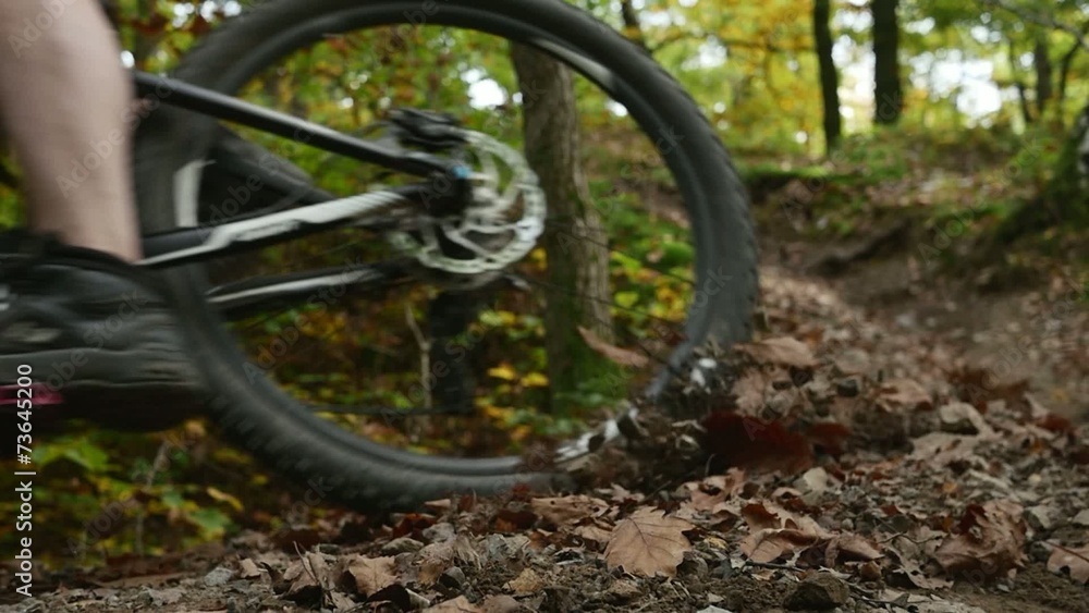 Stones flying towards the camera after mountain bicycle passes Stones flying towards the camera after mountain bicycle passes