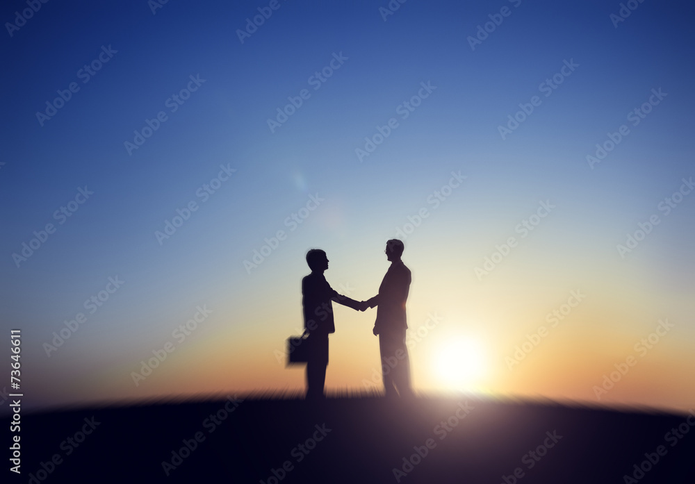 Silhouette of Two Businessmen Shaking Hand Concept