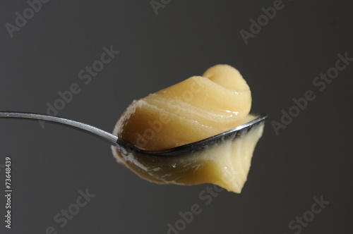 pasty honey on metal spoon