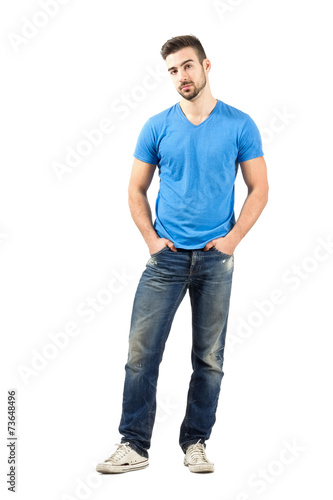 Serious man posing with hands in pockets