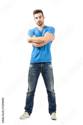 Man with wrapped arms posing at camera