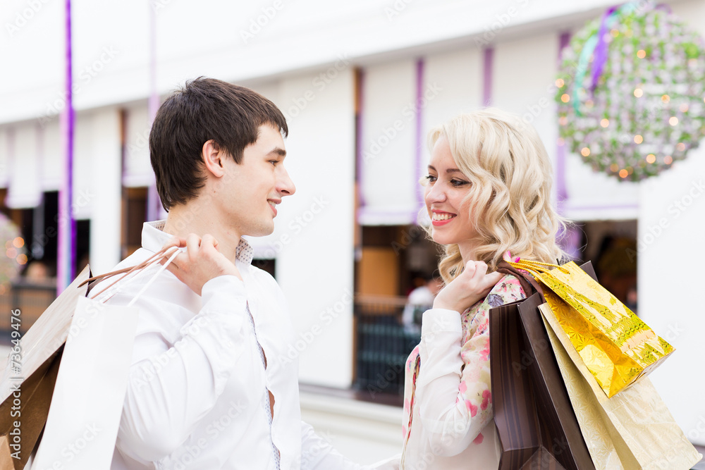 Happy young couple with shopping bags Happy young couple with shopping bags