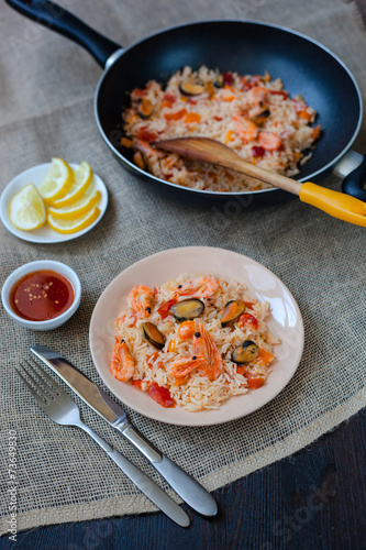 Spanish dish paella with seafood, shrimps in pan
