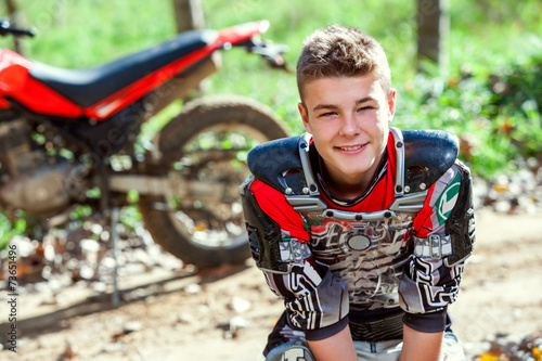 Fotografía Portrait of cute motocross rider outdoors.