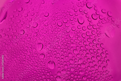 close up shot of water drops on glass surface as background.