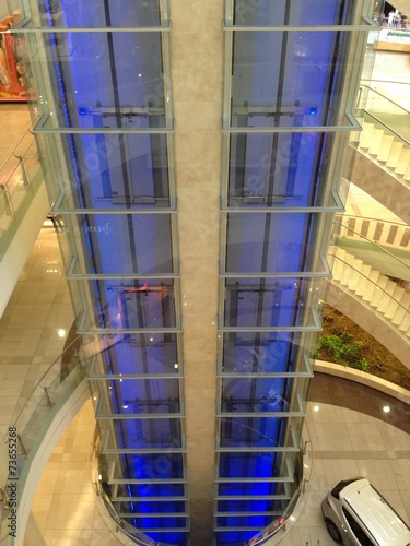 Glass elevator shaft in mall plaza