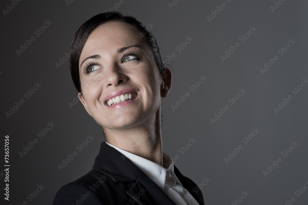 Confident female manager posing on dark background Confident female manager posing on dark background