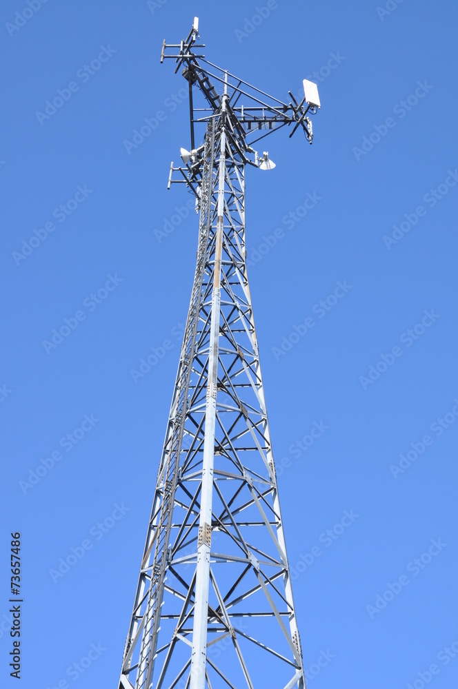 Telecommunication tower with antennas against the blue sky Telecommunication tower with antennas against the blue sky