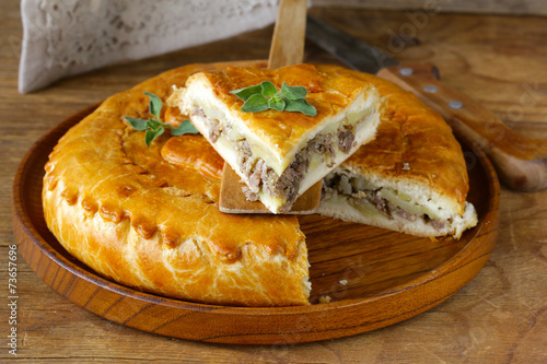 Canvastavla homemade meat pie with potatoes and oregano