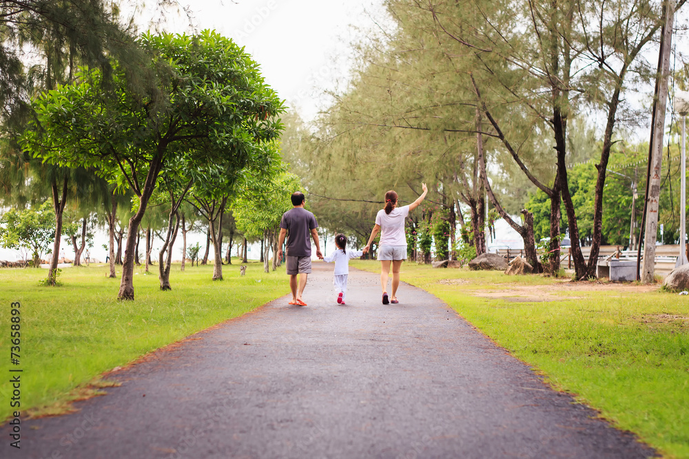 Family walking at park in the morning Family walking at park in the morning