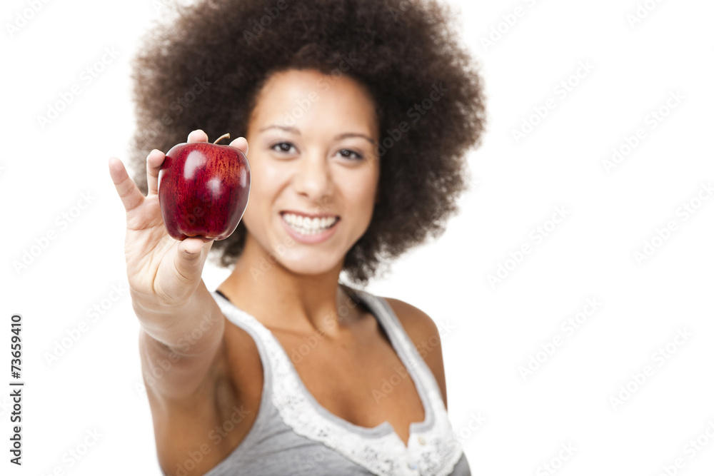 African American young woman holding and showing a red apple African American young woman holding and showing a red apple