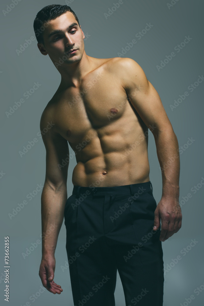 Male beauty concept. Fashionable and undressed young man in blac Male beauty concept. Fashionable and undressed young man in blac