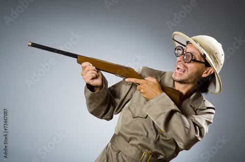 Funny safari hunter with rifle