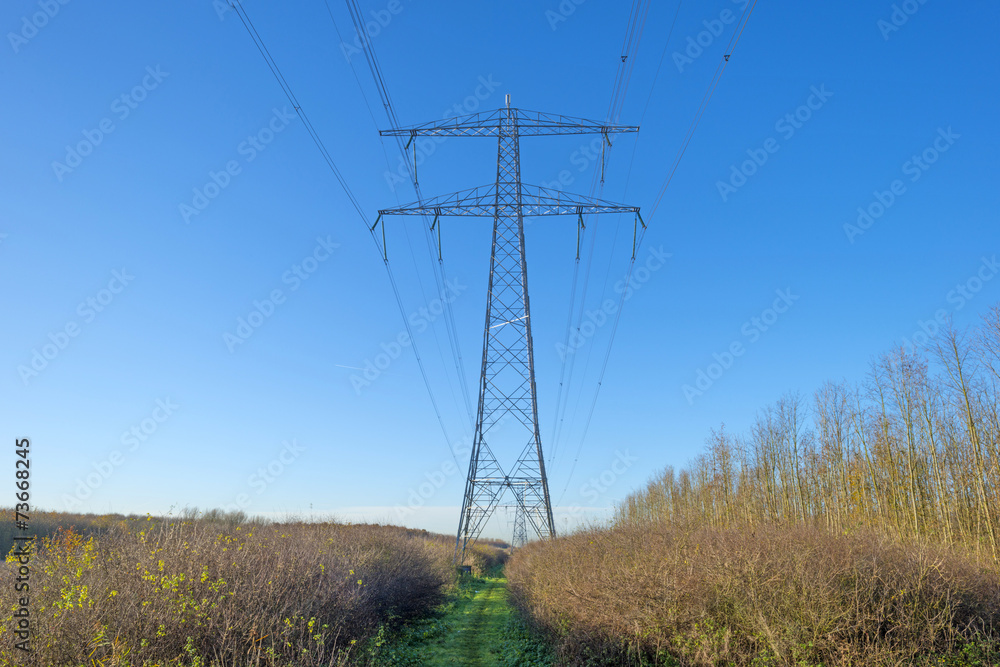 Transmission tower under a sunny sky at fall