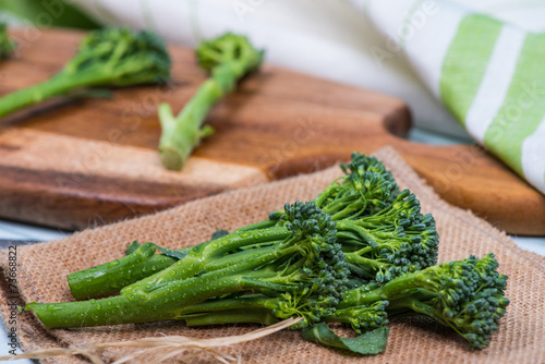 fresh green broccolini on table photo