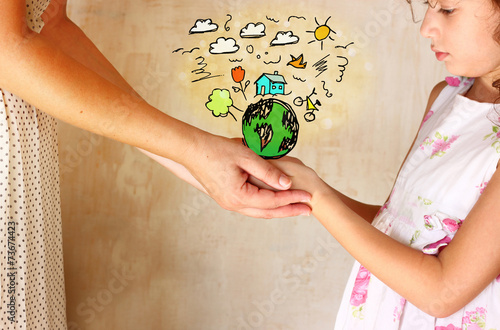 Quadro em tela photo of mother and child holding hands and showing a better wor