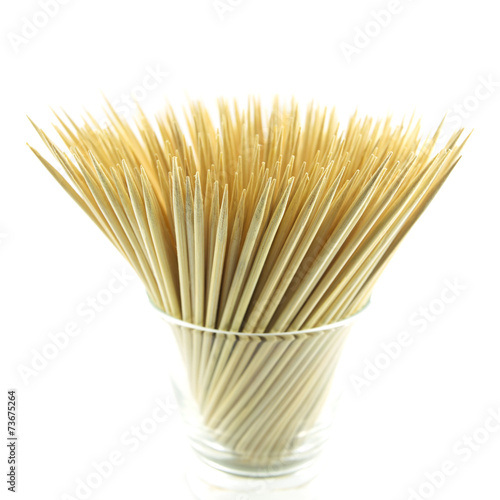 pile of wooden bamboo skewers on white background