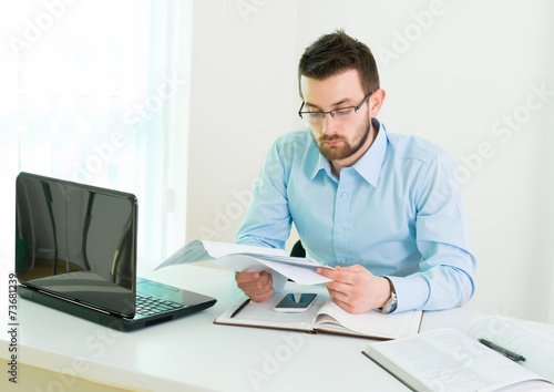Young businessman working in office.