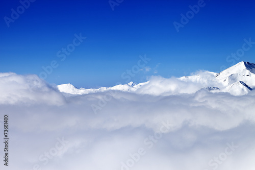 Mountains under clouds in sun day