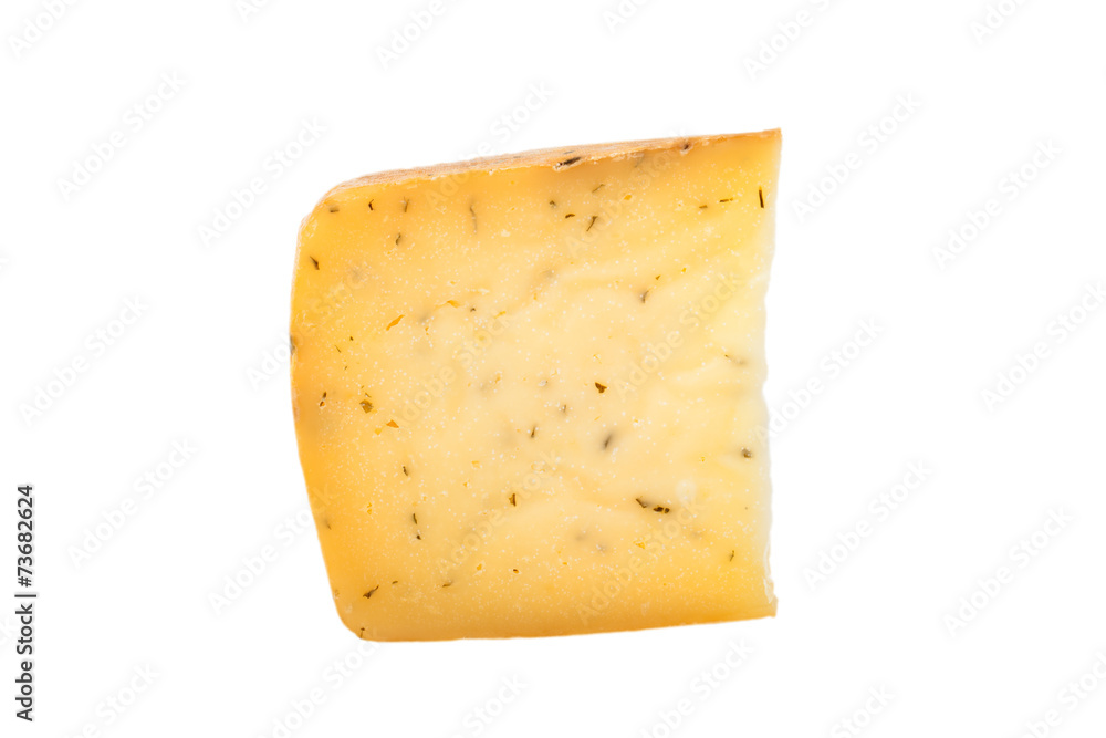 triangular piece of cheese with herbs isolated on a white backgr triangular piece of cheese with herbs isolated on a white backgr
