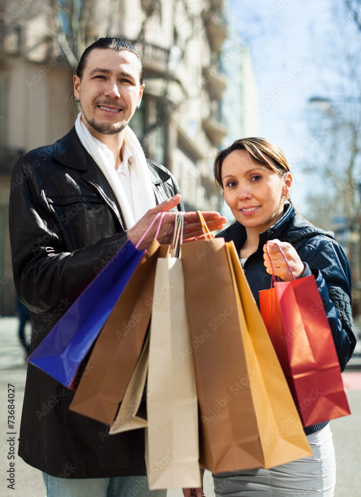  couple in black jackets with purchases
