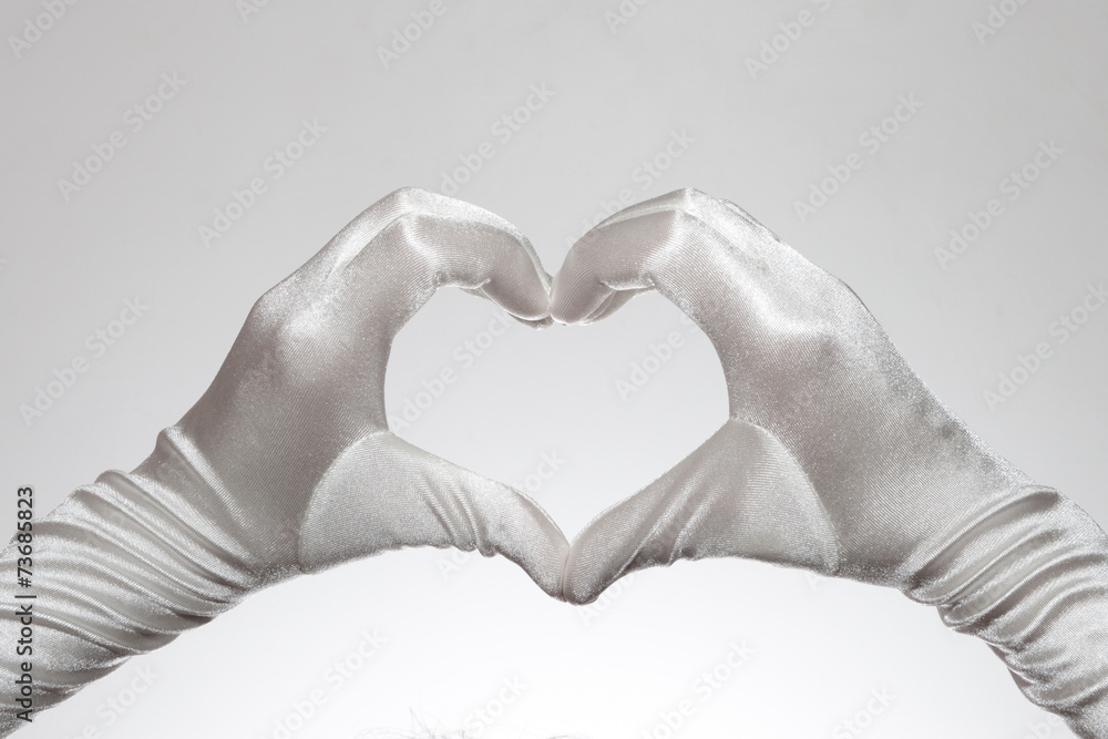 Obraz premium White women's heart shaped gloves isolated on white background