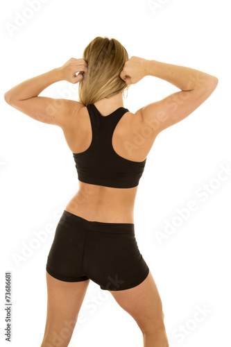 woman fitness black bra and shorts back