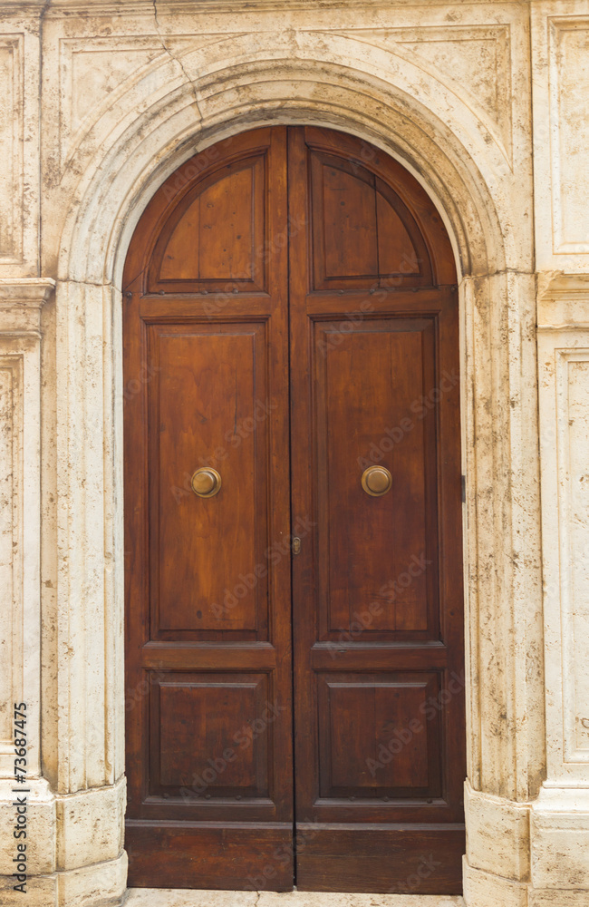 The old wooden door seen in Siena. Tuscany. Italy The old wooden door seen in Siena. Tuscany. Italy