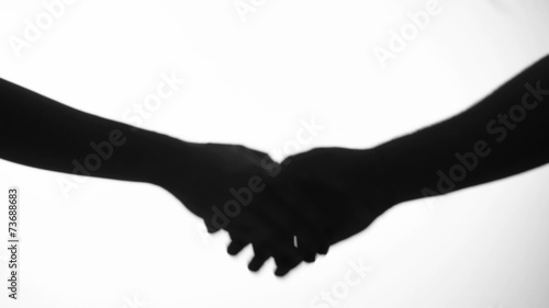 hand shake man and woman in silhouette