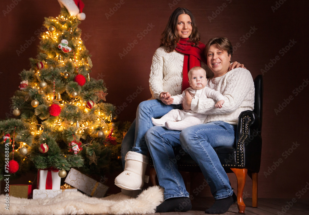 Happy family near Christmas tree at home