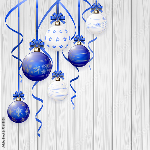 Blue Christmas balls and tinsel on wooden background