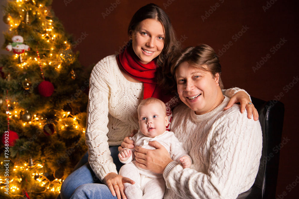 Happy family near Christmas tree at home