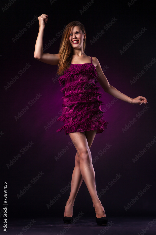 Beautiful woman in purple dress dancing Beautiful woman in purple dress dancing