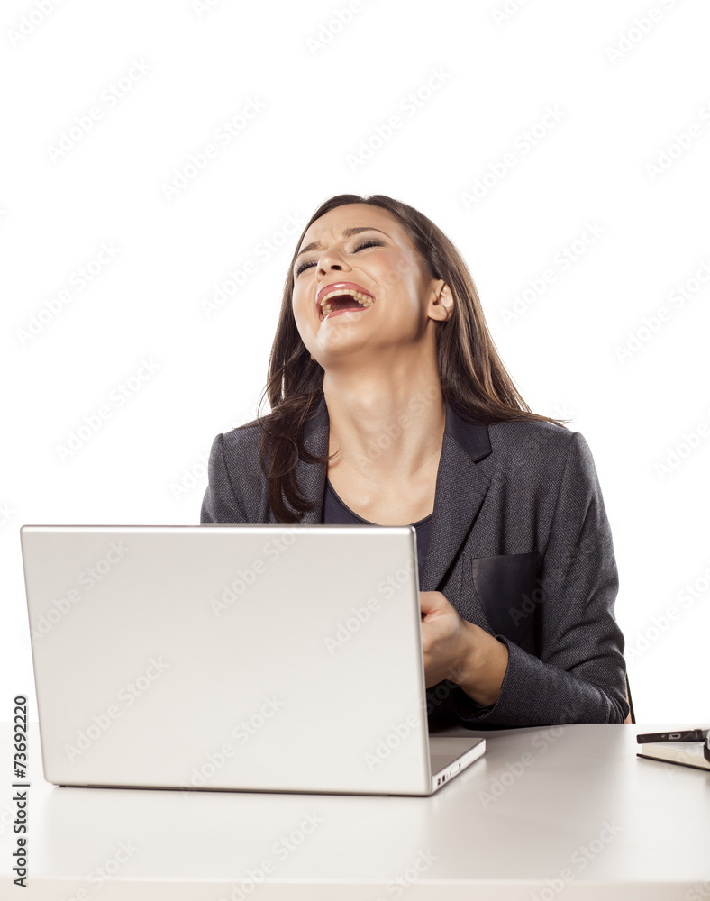 young unhappy businesswoman crying behind her laptop young unhappy businesswoman crying behind her laptop